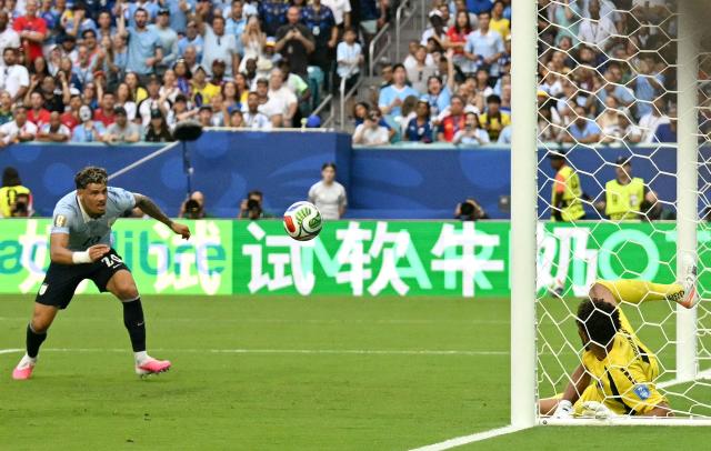 Uruguay's midfielder #20 Maximiliano Araujo scores his team's first goal during the 2026 World Cup Group H football match between Uruguay and Cape Verde at the Miami Stadium in Miami Gardens on June 21, 2026.  (Photo by CHANDAN KHANNA / AFP)