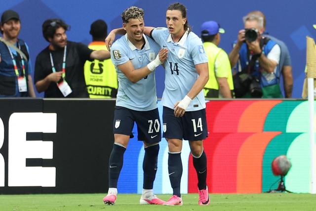 Uruguay's forward #14 Agustin Canobbio celebrates with teammate midfielder #20 Maximiliano Araujo scoring his team's second goal during the 2026 World Cup Group H football match between Uruguay and Cape Verde at the Miami Stadium in Miami Gardens on June 21, 2026.  (Photo by PATRICIA DE MELO MOREIRA / AFP)