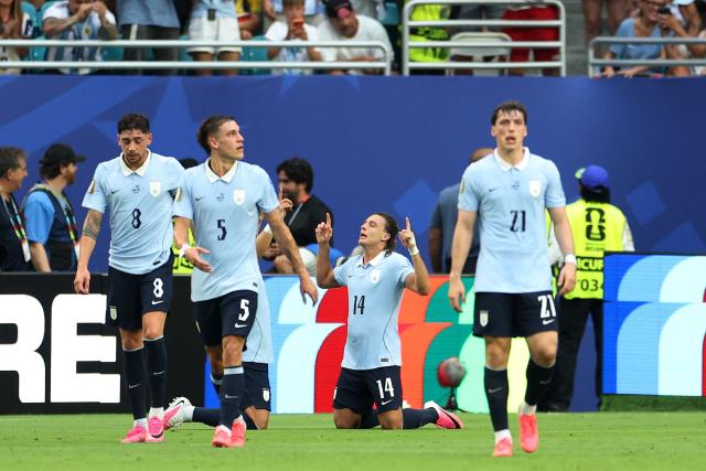 Uruguay's forward #14 Agustin Canobbio celebrates scoring his team's second goal next to teammates midfielder #08 Federico Valverde, midfielder #05 Manuel Ugarte and forward #21 Federico Vinas during the 2026 World Cup Group H football match between Uruguay and Cape Verde at the Miami Stadium in Miami Gardens on June 21, 2026.  (Photo by PATRICIA DE MELO MOREIRA / AFP)