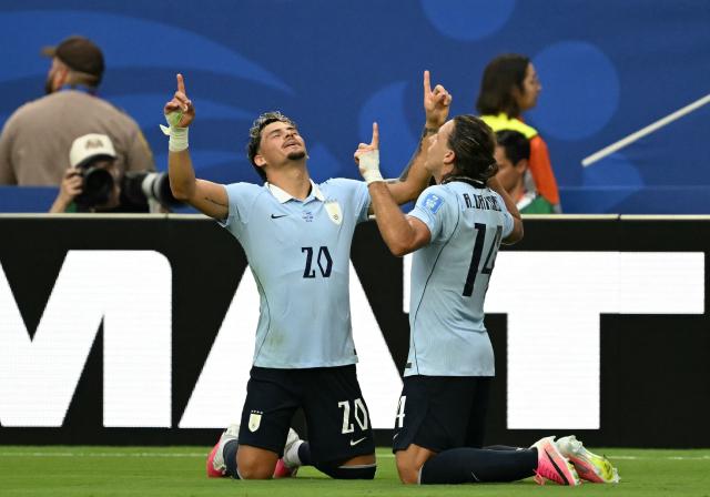 Uruguay's forward #14 Agustin Canobbio celebrates after scoring his team's second goal with teammate midfielder #20 Maximiliano Araujo during the 2026 World Cup Group H football match between Uruguay and Cape Verde at the Miami Stadium in Miami Gardens on June 21, 2026.  (Photo by CHANDAN KHANNA / AFP)