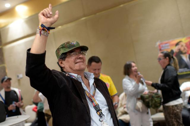 A supporter of Colombia's presidential candidate for the Defensores de la Patria movement Abelardo de la Espriella celebrates the results of the presidential runoff election in Bogota, on June 21, 2026. A flamboyant US-backed lawyer who has never held public office narrowly won Colombia's presidential runoff on June 21, swinging the country hard to the right on a promise to wage war against drug-running guerrilla groups. With more than 99 percent of polling centers reporting, Abelardo de la Espriella had 49.67 percent of the vote, an unassailable lead over his rival, left-wing Senator Ivan Cepeda who trailed at 48.69 percent, according to official results. (Photo by Sebastian BARROS / AFP)