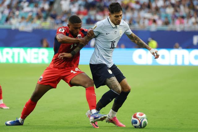 Cape Verde's midfielder #14 Deroy Duarte and Uruguay's defender #16 Mathias Olivera fight for the ball during the 2026 World Cup Group H football match between Uruguay and Cape Verde at the Miami Stadium in Miami Gardens on June 21, 2026.  (Photo by PATRICIA DE MELO MOREIRA / AFP)