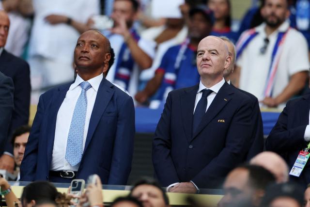 President of the Confederation of African Football Patrice Motsepe and FIFA President Gianni Infantino are seen ahead of the 2026 World Cup Group H football match between Uruguay and Cape Verde at the Miami Stadium in Miami Gardens on June 21, 2026.  (Photo by PATRICIA DE MELO MOREIRA / AFP)