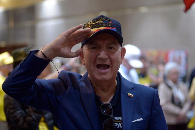 A supporter of Colombia's presidential candidate for the Defensores de la Patria movement Abelardo de la Espriella celebrates the results of the presidential runoff election in Bogota, on June 21, 2026. A flamboyant US-backed lawyer who has never held public office narrowly won Colombia's presidential runoff on June 21, swinging the country hard to the right on a promise to wage war against drug-running guerrilla groups. With more than 99 percent of polling centers reporting, Abelardo de la Espriella had 49.67 percent of the vote, an unassailable lead over his rival, left-wing Senator Ivan Cepeda who trailed at 48.69 percent, according to official results. (Photo by Sebastian BARROS / AFP)