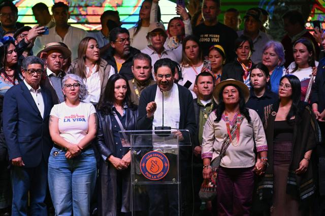 Colombia's presidential candidate for the ruling Pacto Historico party, Ivan Cepeda (C), speaks next to running mate Aida Quilcue (C, right) after the first results of the presidential election runoff at the Tequendama Hotel in Bogota on June 21, 2026. A flamboyant US-backed lawyer who has never held public office narrowly won Colombia's presidential runoff on June 21, swinging the country hard to the right on a promise to wage war against drug-running guerrilla groups. With more than 99 percent of polling centers reporting, Abelardo de la Espriella had 49.67 percent of the vote, an unassailable lead over his rival, left-wing Senator Ivan Cepeda who trailed at 48.69 percent, according to official results. (Photo by Raul ARBOLEDA / AFP)