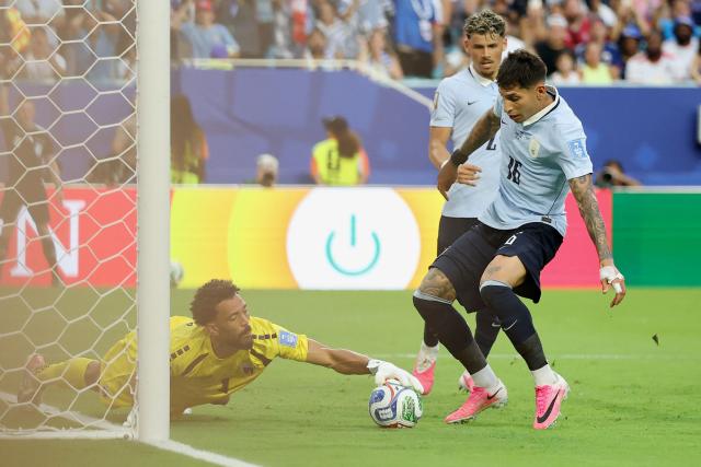 Cape Verde's goalkeeper #01 Vozinha makes a save past Uruguay's defender #16 Mathias Olivera during the 2026 World Cup Group H football match between Uruguay and Cape Verde at the Miami Stadium in Miami Gardens on June 21, 2026.  (Photo by PATRICIA DE MELO MOREIRA / AFP)