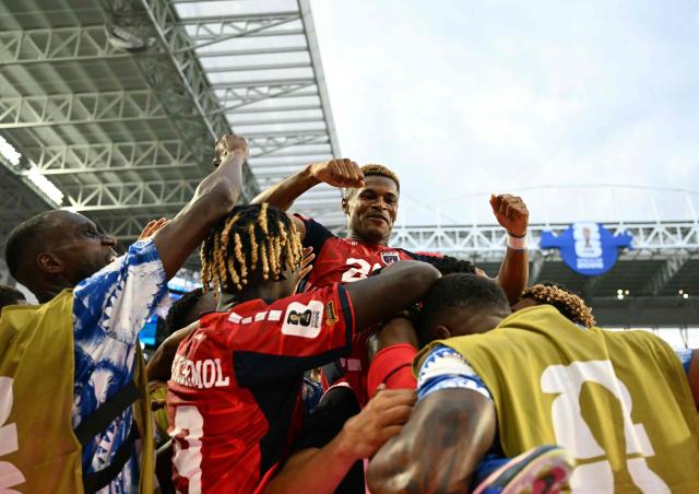 Cape Verde's forward #26 Helio Varela celebrates with teammates after scoring his team's second goal during the 2026 World Cup Group H football match between Uruguay and Cape Verde at the Miami Stadium in Miami Gardens on June 21, 2026.  (Photo by CHANDAN KHANNA / AFP)
