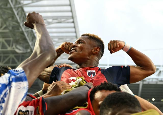 Cape Verde's forward #26 Helio Varela celebrates with teammates after scoring his team's second goal during the 2026 World Cup Group H football match between Uruguay and Cape Verde at the Miami Stadium in Miami Gardens on June 21, 2026.  (Photo by CHANDAN KHANNA / AFP)
