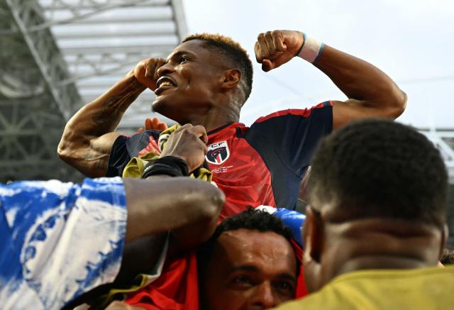 Cape Verde's forward #26 Helio Varela celebrates with teammates after scoring his team's second goal during the 2026 World Cup Group H football match between Uruguay and Cape Verde at the Miami Stadium in Miami Gardens on June 21, 2026.  (Photo by CHANDAN KHANNA / AFP)