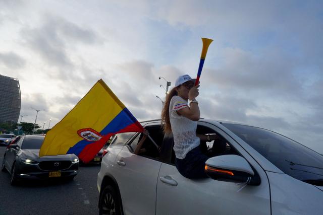 Supporters of Colombia's presidential candidate for the Defensores de la Patria movement, Abelardo de la Espriella, celebrate the results of the presidential runoff election in Barranquilla, Colombia on June 21, 2026. A flamboyant US-backed lawyer who has never held public office narrowly won Colombia's presidential runoff on June 21, swinging the country hard to the right on a promise to wage war against drug-running guerrilla groups. With more than 99 percent of polling centers reporting, Abelardo de la Espriella had 49.67 percent of the vote, an unassailable lead over his rival, left-wing Senator Ivan Cepeda who trailed at 48.69 percent, according to official results. (Photo by Vanexa Romero / AFP)