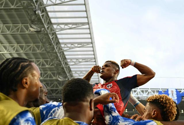 Cape Verde's forward #26 Helio Varela celebrates with teammates after scoring his team's second goal during the 2026 World Cup Group H football match between Uruguay and Cape Verde at the Miami Stadium in Miami Gardens on June 21, 2026.  (Photo by CHANDAN KHANNA / AFP)