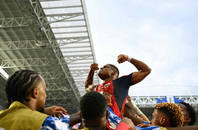 Cape Verde's forward #26 Helio Varela celebrates with teammates after scoring his team's second goal during the 2026 World Cup Group H football match between Uruguay and Cape Verde at the Miami Stadium in Miami Gardens on June 21, 2026.  (Photo by CHANDAN KHANNA / AFP)