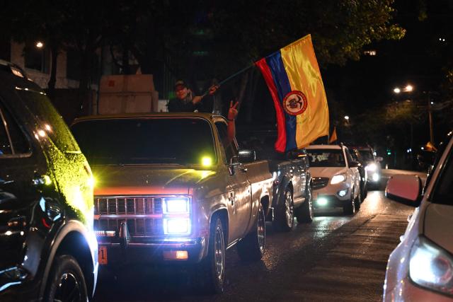 Supporters of Colombia's presidential candidate for the Defensores de la Patria movement, Abelardo de la Espriella, celebrate the results of the presidential runoff election in Bogota on June 21, 2026. A flamboyant US-backed lawyer who has never held public office narrowly won Colombia's presidential runoff on June 21, swinging the country hard to the right on a promise to wage war against drug-running guerrilla groups. With more than 99 percent of polling centers reporting, Abelardo de la Espriella had 49.67 percent of the vote, an unassailable lead over his rival, left-wing Senator Ivan Cepeda who trailed at 48.69 percent, according to official results. (Photo by Raul ARBOLEDA / AFP)