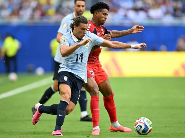 Uruguay's forward #14 Agustin Canobbio and Cape Verde's midfielder #06 Kevin Pina fight for the ball during the 2026 World Cup Group H football match between Uruguay and Cape Verde at the Miami Stadium in Miami Gardens on June 21, 2026.  (Photo by CHANDAN KHANNA / AFP)