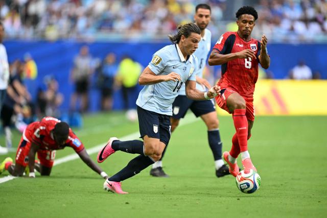 Uruguay's forward #14 Agustin Canobbio and Cape Verde's midfielder #06 Kevin Pina fight for the ball during the 2026 World Cup Group H football match between Uruguay and Cape Verde at the Miami Stadium in Miami Gardens on June 21, 2026.  (Photo by CHANDAN KHANNA / AFP)