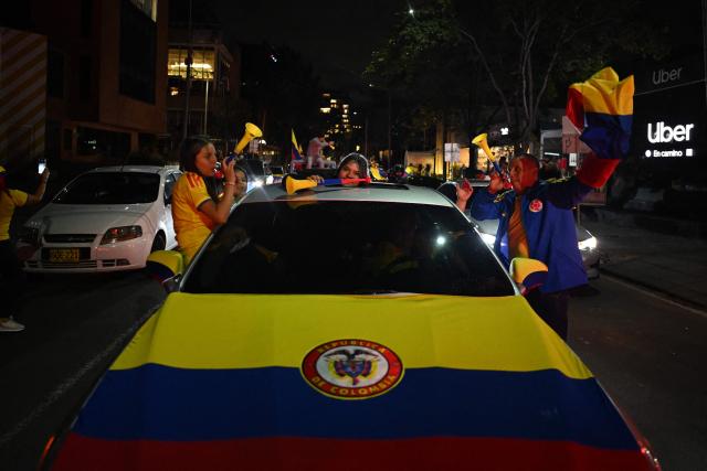 Supporters of Colombia's presidential candidate for the Defensores de la Patria movement, Abelardo de la Espriella, celebrate the results of the presidential runoff election in Bogota on June 21, 2026. A flamboyant US-backed lawyer who has never held public office narrowly won Colombia's presidential runoff on June 21, swinging the country hard to the right on a promise to wage war against drug-running guerrilla groups. With more than 99 percent of polling centers reporting, Abelardo de la Espriella had 49.67 percent of the vote, an unassailable lead over his rival, left-wing Senator Ivan Cepeda who trailed at 48.69 percent, according to official results. (Photo by Luis ACOSTA / AFP)