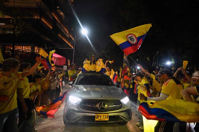 Supporters of Colombia's presidential candidate for the Defensores de la Patria movement, Abelardo de la Espriella, celebrate the results of the presidential runoff election in Bogota on June 21, 2026. A flamboyant US-backed lawyer who has never held public office narrowly won Colombia's presidential runoff on June 21, swinging the country hard to the right on a promise to wage war against drug-running guerrilla groups. With more than 99 percent of polling centers reporting, Abelardo de la Espriella had 49.67 percent of the vote, an unassailable lead over his rival, left-wing Senator Ivan Cepeda who trailed at 48.69 percent, according to official results. (Photo by Luis ACOSTA / AFP)