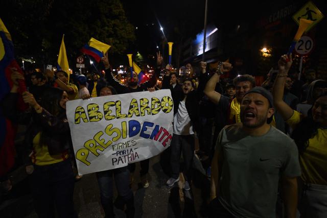 Supporter of Colombia's presidential candidate for the Defensores de la Patria movement, Abelardo de la Espriella, celebrate the results of the presidential runoff election in Bogota on June 21, 2026. A flamboyant US-backed lawyer who has never held public office narrowly won Colombia's presidential runoff on June 21, swinging the country hard to the right on a promise to wage war against drug-running guerrilla groups. With more than 99 percent of polling centers reporting, Abelardo de la Espriella had 49.67 percent of the vote, an unassailable lead over his rival, left-wing Senator Ivan Cepeda who trailed at 48.69 percent, according to official results. (Photo by Luis ACOSTA / AFP)