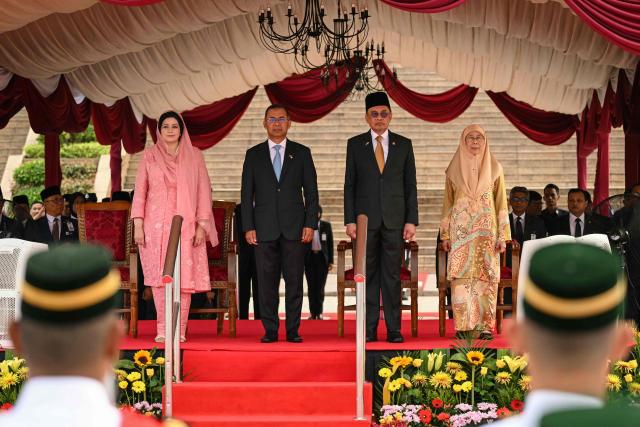 Malaysia's Prime Minister Anwar Ibrahim (2nd R) and his wife Wan Azizah Wan Ismail (R) stand with Bangladesh's Prime Minister Tarique Rahman (2nd L) and his wife Zubaida Rahman during a welcome ceremony at the Federal Government office "Putra Perdana" in Putrajaya on June 22, 2026. (Photo by MOHD RASFAN / AFP)