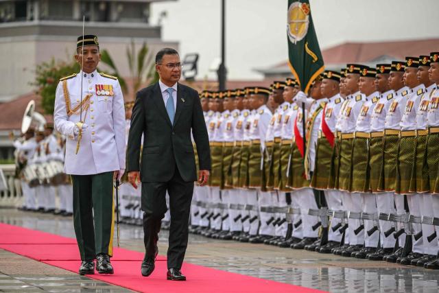 Bangladesh's Prime Minister Tarique Rahman reviews Malaysian honour guards during a welcome ceremony at the Federal Government office "Putra Perdana" in Putrajaya on June 22, 2026. (Photo by MOHD RASFAN / AFP)