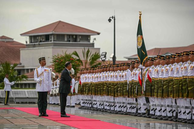 Bangladesh's Prime Minister Tarique Rahman reviews Malaysian honour guards during a welcome ceremony at the Federal Government office "Putra Perdana" in Putrajaya on June 22, 2026. (Photo by MOHD RASFAN / AFP)