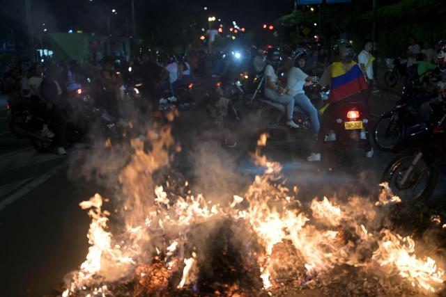 Supporters of Colombia's presidential candidate Ivan Cepeda of the ruling Pacto Historico party protest the results of the presidential runoff election in Cali, Colombia, on June 21, 2026. A flamboyant US-backed lawyer who has never held public office narrowly won Colombia's presidential runoff Sunday, swinging the country hard to the right on a promise to wage war against drug-running guerrilla groups. With more than 99 percent of polling centers reporting, Abelardo de la Espriella had 49.67 percent of the vote, an unassailable lead over his rival, left-wing Senator Ivan Cepeda who trailed at 48.69 percent, according to official results. (Photo by JOAQUIN SARMIENTO / AFP)