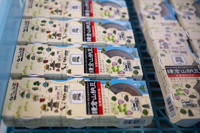 This photo taken on May 15, 2026 shows packed natto at the Kamakurayama Natto production facility in Kamakura, Kanagawa prefecture. The highly nutritious beans inoculated with beneficial bacteria remain a traditional Japanese breakfast staple, but their pungent aroma, viscous texture and yeasty taste divide even their homeland. Recent years have seen natto join a series of fermented foods, from kimchi to kombucha, that have surged in popularity worldwide as Americans in particular seek better digestive health following the Covid-19 pandemic. (Photo by Andrew CABALLERO-REYNOLDS / AFP) / To go with AFP story Japan-food-health-natto-lifestyle,FEATURE by Tomohiro Osaki and Sarah Lai