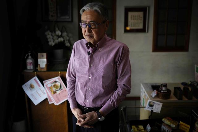 This photo taken on May 15, 2026 shows Yoshihiro Noro, owner of the Kamakurayama Natto production facility, posing for a photo at his store in Kamakura, Kanagawa prefecture. The highly nutritious beans inoculated with beneficial bacteria remain a traditional Japanese breakfast staple, but their pungent aroma, viscous texture and yeasty taste divide even their homeland. Recent years have seen natto join a series of fermented foods, from kimchi to kombucha, that have surged in popularity worldwide as Americans in particular seek better digestive health following the Covid-19 pandemic. (Photo by Andrew CABALLERO-REYNOLDS / AFP) / To go with AFP story Japan-food-health-natto-lifestyle,FEATURE by Tomohiro Osaki and Sarah Lai