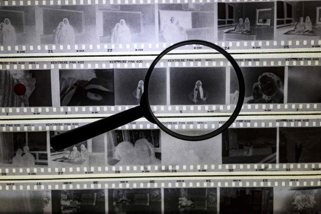 This photograph shows a picture from a camera film viewed through a magnifying glass during a workshop held as part of Fotohane Darkroom project in Mardin, southeastern Turkey, on June 14, 2026. In a dimly lit room illuminated by a pair of red lamps, eight-year-old Zeynep waits to see the photographs she has taken, now trapped as shadows and silhouettes on a roll of film. Originally from the southeastern province of Mardin, Zeynep is among eight children taking part in a two-month analog photography workshop for local and migrant youth near Turkey's borders with Iraq and Syria. The project, called Fotohane Darkroom, started in Mardin in 2024, by Kilic and Syrian photographer and educator Serbest Salih. In Turkish, Arabic, Kurdish and Persian, Fotohane means "house of photo", a name chosen by the children. (Photo by Yasin AKGUL / AFP)