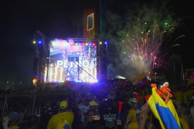 Supporters of Colombia's presidential candidate for the Defensores de la Patria movement Abelardo de la Espriella celebrate the results of the presidential runoff election at the Ventana al Mundo monument in Barranquilla, Colombia, on June 21, 2026. A flamboyant US-backed lawyer who has never held public office narrowly won Colombia's presidential runoff on June 21, swinging the country hard to the right on a promise to wage war against drug-running guerrilla groups. With more than 99 percent of polling centers reporting, Abelardo de la Espriella had 49.67 percent of the vote, an unassailable lead over his rival, left-wing Senator Ivan Cepeda who trailed at 48.69 percent, according to official results. (Photo by Vanexa Romero / AFP)
