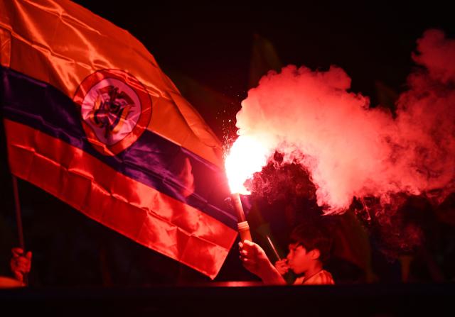 Supporters of Colombia's presidential candidate for the Defensores de la Patria movement, Abelardo de la Espriella, light flares following the preliminary results of the presidential runoff election at the Ventana al Mundo monument in Barranquilla, Colombia, on June 21, 2026. A flamboyant US-backed lawyer who has never held public office narrowly won Colombia's presidential runoff on June 21, swinging the country hard to the right on a promise to wage war against drug-running guerrilla groups. With just a handful of polling centers left to report, Abelardo de la Espriella had 49.65 percent of the vote -- an unassailable lead over left-wing Senator Ivan Cepeda who trailed on 48.70 percent. (Photo by Juan BARRETO / AFP)