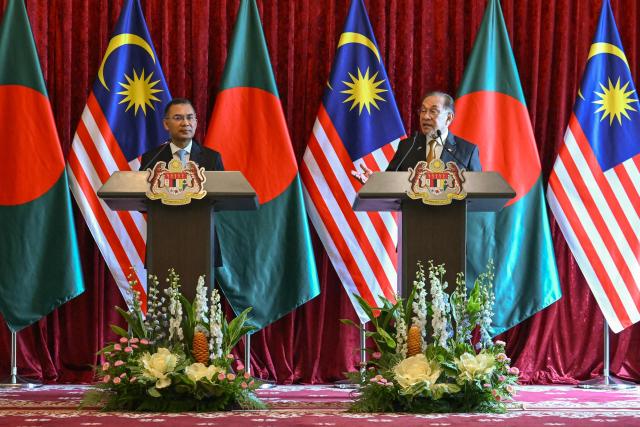 Bangladesh's Prime Minister Tarique Rahman (L) and Malaysia's Prime Minister Anwar Ibrahim attend a press conference at the Federal Government office "Putra Perdana" in Putrajaya on June 22, 2026. (Photo by MOHD RASFAN / POOL / AFP)