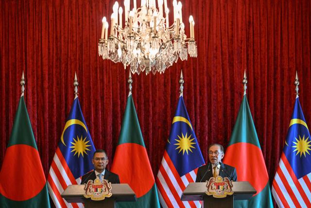 Bangladesh's Prime Minister Tarique Rahman (L) and Malaysia's Prime Minister Anwar Ibrahim attend a press conference at the Federal Government office "Putra Perdana" in Putrajaya on June 22, 2026. (Photo by MOHD RASFAN / POOL / AFP)
