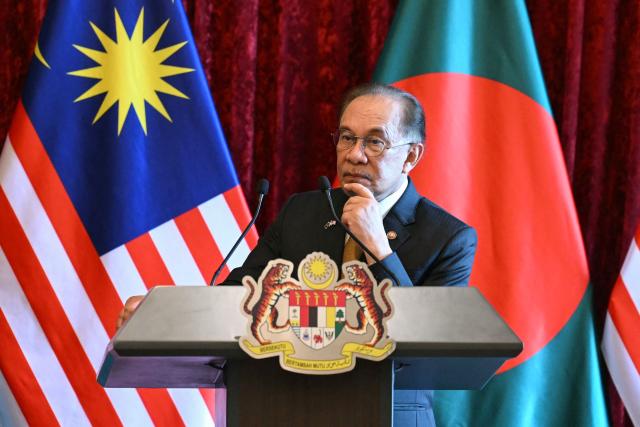 Malaysia's Prime Minister Anwar Ibrahim listens during a press conference with Bangladesh's Prime Minister Tarique Rahman at the Federal Government office "Putra Perdana" in Putrajaya on June 22, 2026. (Photo by MOHD RASFAN / POOL / AFP)