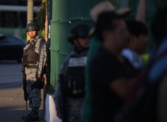 A Mexico's National Guard Member looks at Iran fans outside the Marriott Hotel in Tijuana, Baja California, Mexico on June 21, 2026. (Photo by Guillermo Arias / AFP)