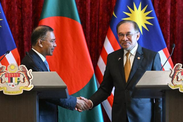 Bangladesh's Prime Minister Tarique Rahman (L) and Malaysia's Prime Minister Anwar Ibrahim shake hands during a press conference at the Federal Government office "Putra Perdana" in Putrajaya on June 22, 2026. (Photo by MOHD RASFAN / POOL / AFP)