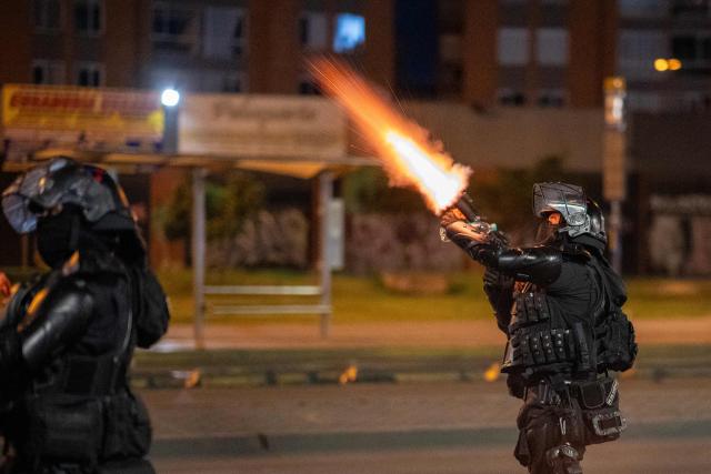 Riot police fire tear gas during clashes with demonstrators protesting the preliminary results of the presidential runoff election in Bogota, Colombia, on June 21, 2026. A flamboyant US-backed lawyer who has never held public office narrowly won Colombia's presidential runoff Sunday, swinging the country hard to the right on a promise to wage war against drug-running guerrilla groups. With more than 99 percent of polling centers reporting, Abelardo de la Espriella had 49.67 percent of the vote, an unassailable lead over his rival, left-wing Senator Ivan Cepeda who trailed at 48.69 percent, according to official results. (Photo by Diego Cuevas / AFP)