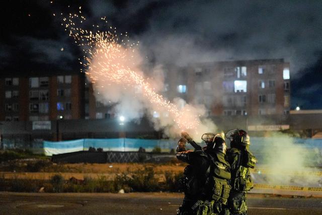 Riot police fire tear gas during clashes with demonstrators protesting the preliminary results of the presidential runoff election in Bogota, Colombia, on June 21, 2026. A flamboyant US-backed lawyer who has never held public office narrowly won Colombia's presidential runoff Sunday, swinging the country hard to the right on a promise to wage war against drug-running guerrilla groups. With more than 99 percent of polling centers reporting, Abelardo de la Espriella had 49.67 percent of the vote, an unassailable lead over his rival, left-wing Senator Ivan Cepeda who trailed at 48.69 percent, according to official results. (Photo by Diego CUEVAS / AFP)