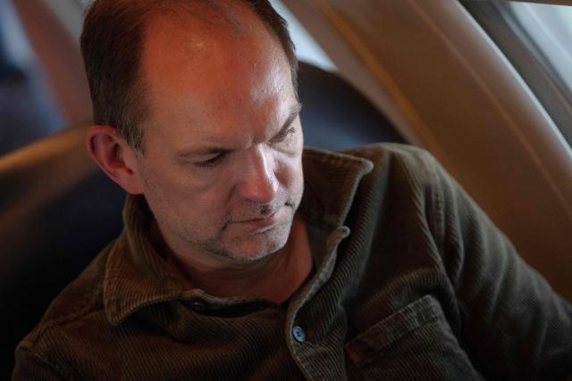 Danish Defence Minister Jeppe Bruus (Social Democrats) works during his flight to Kangerlussuaq, Greenland, on the evening of June 21, 2026. Bad weather prevented his planned landing in Nuuk, forcing a diversion to Kangerlussuaq. (Photo by Mads Claus Rasmussen / Ritzau Scanpix / AFP) / Denmark OUT