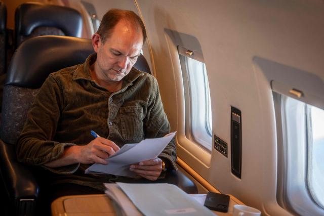 Danish Defence Minister Jeppe Bruus (Social Democrats) works during his flight to Kangerlussuaq, Greenland, on the evening of June 21, 2026. Bad weather prevented his planned landing in Nuuk, forcing a diversion to Kangerlussuaq. (Photo by Mads Claus Rasmussen / Ritzau Scanpix / AFP) / Denmark OUT