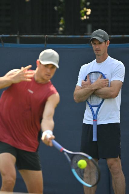 Britain's Andy Murray (R), now coaching, watches Britain's Jack Draper practice ahead of his men's singles round of 32 tennis match on day one of the Lexus Eastbourne Open at Devonshire Park, Eastbourne, on the south coast of England on June 22, 2026. (Photo by Glyn KIRK / AFP)