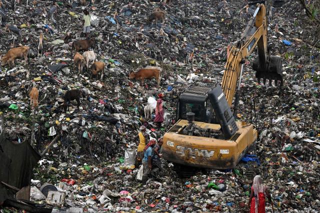 CORRECTION / Rag pickers look for recyclable materials at the Boragaon dumping site in Guwahati on June 4, 2026. (Photo by Biju BORO / AFP) / “The erroneous mention[s] appearing in the metadata of this photo by Biju BORO has been modified in AFP systems in the following manner: [ June 4, 2026 ] instead of [ June 5, 2024 ]. Please immediately remove the erroneous mention[s] from all your online services and delete it (them) from your servers. If you have been authorized by AFP to distribute it (them) to third parties, please ensure that the same actions are carried out by them. Failure to promptly comply with these instructions will entail liability on your part for any continued or post notification usage. Therefore we thank you very much for all your attention and prompt action. We are sorry for the inconvenience this notification may cause and remain at your disposal for any further information you may require.”