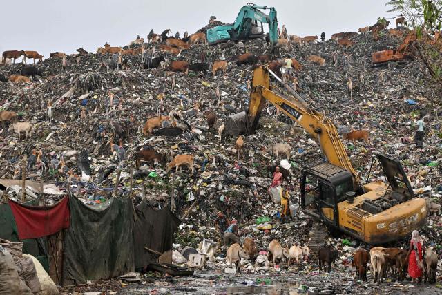 CORRECTION / Rag pickers look for recyclable materials at the Boragaon dumping site in Guwahati on June 4, 2026. (Photo by Biju BORO / AFP) / “The erroneous mention[s] appearing in the metadata of this photo by Biju BORO has been modified in AFP systems in the following manner: [ June 4, 2026 ] instead of [ June 5, 2024 ]. Please immediately remove the erroneous mention[s] from all your online services and delete it (them) from your servers. If you have been authorized by AFP to distribute it (them) to third parties, please ensure that the same actions are carried out by them. Failure to promptly comply with these instructions will entail liability on your part for any continued or post notification usage. Therefore we thank you very much for all your attention and prompt action. We are sorry for the inconvenience this notification may cause and remain at your disposal for any further information you may require.”