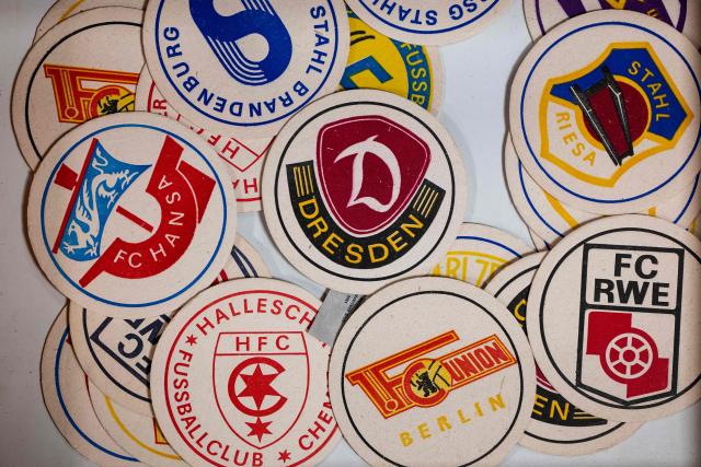 Beer mats featuring the names of East German football teams are on display at the DDR Museum Depot in Berlin on June 17, 2026. The museum collects and preserves cultural assets of the former Communist German Democratic Republic (GDR) having assembled over 400,000 different objects in their collection. (Photo by John MACDOUGALL / AFP)