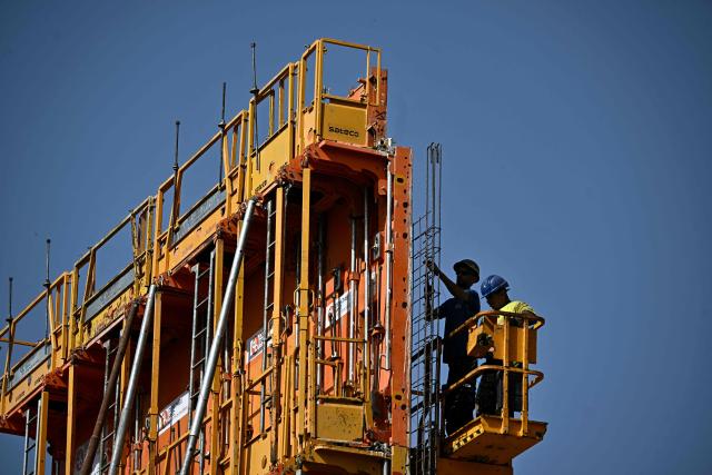 Labourers work at a construction site in Bordeaux, southwestern France on June 22, 2026, as France experiences a ferocious heatwave. France was set on June 22, 2026 to experience the hottest day yet in its latest heatwave after a sweltering night, with a peak of 43C expected in the southwest. In a first, France's highest heat warning was issued across half the country for June 22, 2026, with forecasters warning the extreme weather episode could end up being as serious as a 2003 heatwave that claimed the lives of nearly 15,000 people nationwide. (Photo by Christophe ARCHAMBAULT / AFP)
