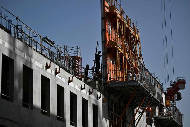 Labourers work at a construction site in Bordeaux, southwestern France on June 22, 2026, as France experiences a ferocious heatwave. France was set on June 22, 2026 to experience the hottest day yet in its latest heatwave after a sweltering night, with a peak of 43C expected in the southwest. In a first, France's highest heat warning was issued across half the country for June 22, 2026, with forecasters warning the extreme weather episode could end up being as serious as a 2003 heatwave that claimed the lives of nearly 15,000 people nationwide. (Photo by Christophe ARCHAMBAULT / AFP)