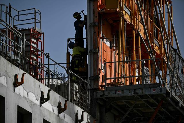 Labourers work at a construction site in Bordeaux, southwestern France on June 22, 2026, as France experiences a ferocious heatwave. France was set on June 22, 2026 to experience the hottest day yet in its latest heatwave after a sweltering night, with a peak of 43C expected in the southwest. In a first, France's highest heat warning was issued across half the country for June 22, 2026, with forecasters warning the extreme weather episode could end up being as serious as a 2003 heatwave that claimed the lives of nearly 15,000 people nationwide. (Photo by Christophe ARCHAMBAULT / AFP)