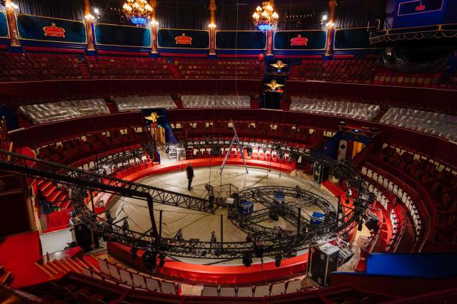 This photograph shows a general view of Paris's Cirque d’Hiver with an employee standing during its renovation, in Paris, on June 22, 2026. (Photo by Dimitar DILKOFF / AFP)