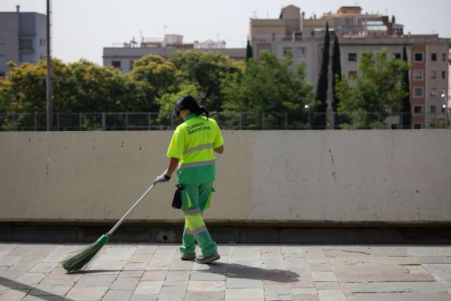 A municipal employee sweeps a street in Barcelona on June 22, 2026, during the heat wave that is affecting the Iberian Peninsula. Large parts of Spain experience unusually high temperatures for June as a mass of hot air from North Africa moves across the Iberian Peninsula. (Photo by Josep LAGO / AFP)