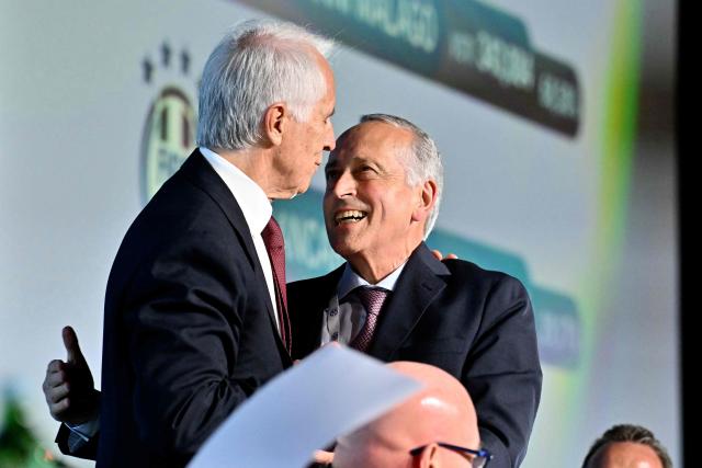 The newly elected President of the Italian Football Federation (FIGC), Giovanni Malago, is congratulated by Giancarlo Abete (R) after his election in Rome on June 22, 2026. (Photo by Filippo MONTEFORTE / AFP)